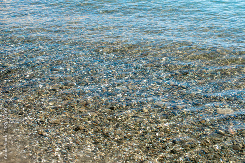 Background Of Sea Pebbles Under Water On Beach. Pebbles under clear water.