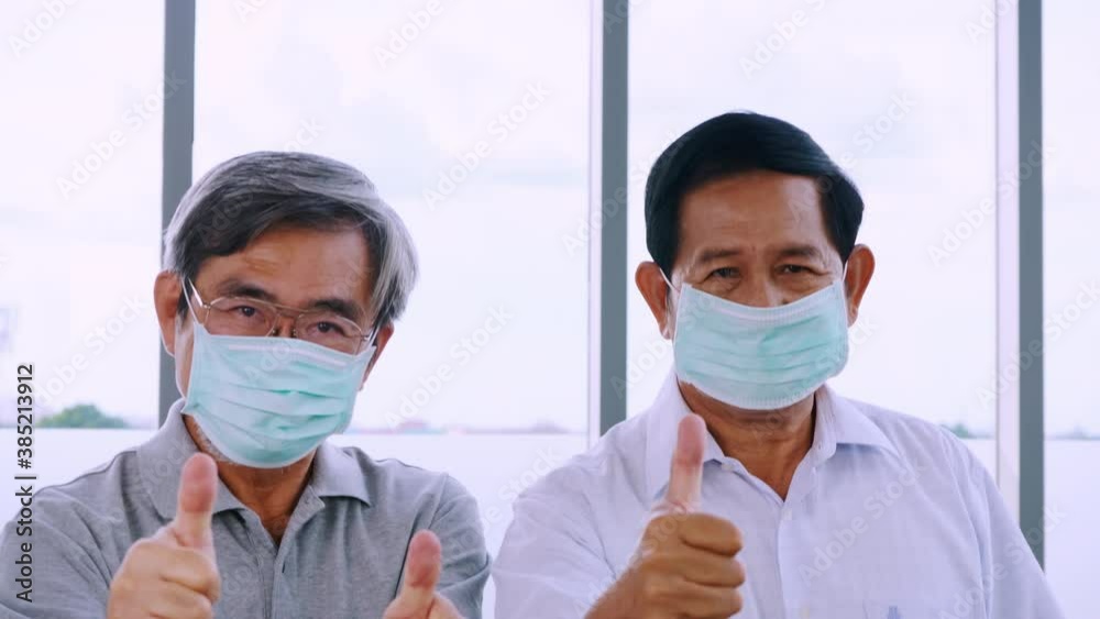 Two senior men wearing protective face masks during quarantine at home. Two senior men wearing protective face masks during quarantine at home.