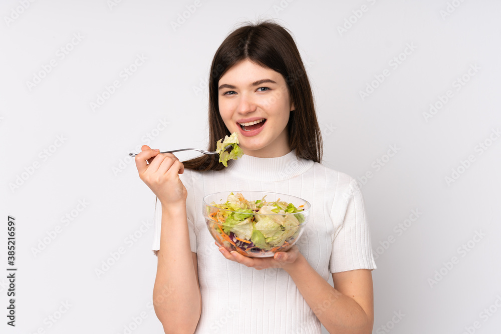 Young Ukrainian teenager girl holding a salad over isolated white background Young Ukrainian teenager girl holding a salad over isolated white background