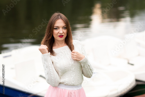 The girl on the pier with catamarans photo