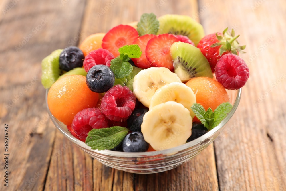 fresh mixed fruit salad on wood background fresh mixed fruit salad on wood background