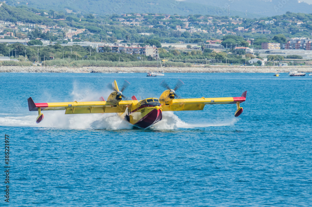 Barcelona, Spain; August 16, 2018: Old yellow fire fighters plane in action.  415