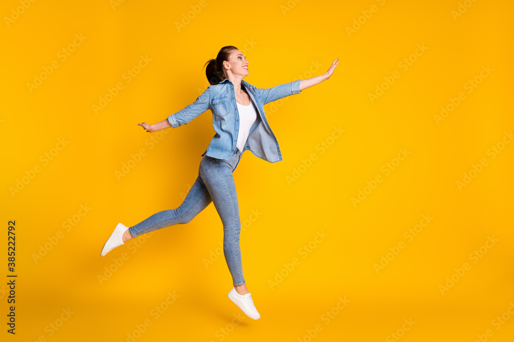Full length body size view of her she nice attractive lovely pretty cheerful cheery carefree girl jumping walking isolated bright vivid shine vibrant yellow color background