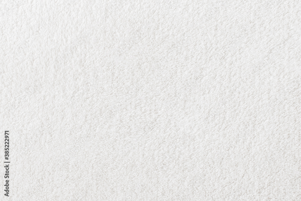 The background image is soft white fur. Fleece close-up texture background. View from above. The background image is soft white fur. Fleece close-up texture background. View from above.