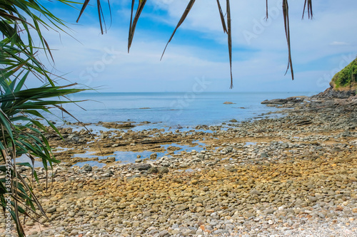 View of the rocky beach through tropical vegetation. Koh Lanta  Thailand