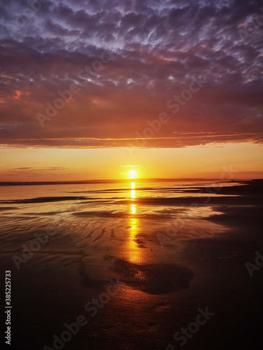 Dramatic sunset on Cefn Sidan beach with Cirrostratus clouds - is a long sandy beach  its dunes form the outer edge of the Pembrey Burrows between Burry Port and Kidwelly.