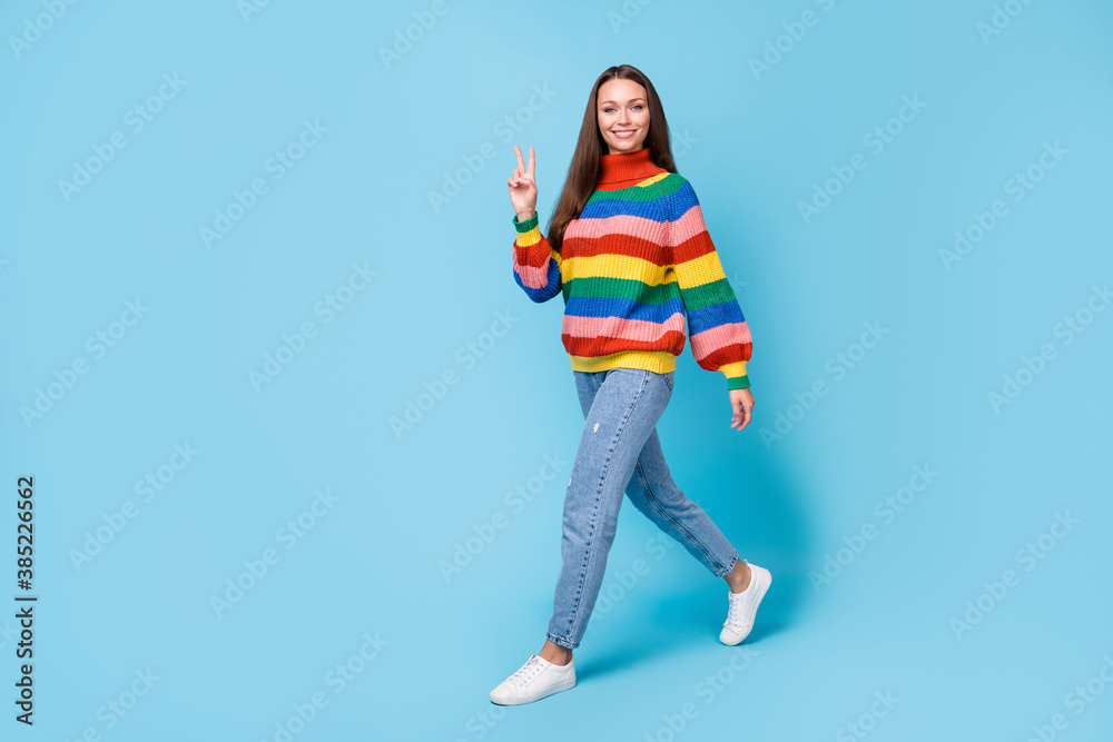 Full length body size view of her she nice attractive lovely cute cheerful cheery girl walking showing v-sign free time isolated bright vivid shine vibrant blue color background Full length body size view of her she nice attractive lovely cute cheerful cheery girl walking showing v-sign free time isolated bright vivid shine vibrant blue color background