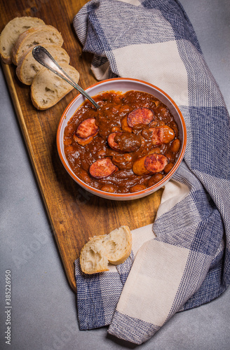 Polish breton beans with bacon, smoked sausages and onion, famous polish dish fasolka po bretonsku, baked beans in tomato sauce photo