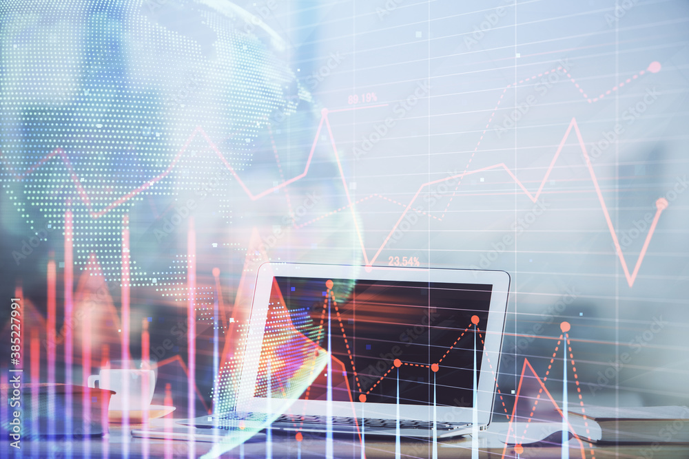 Forex Chart hologram on table with computer background. Double exposure. Concept of financial markets. Forex Chart hologram on table with computer background. Double exposure. Concept of financial markets.