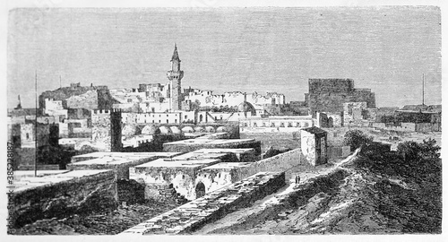 Tripoli cityscape and part of barren surrounding ground, Libya. Ancient grey tone etching style art by Lancelot, published on Le Tour du Monde, Paris, 1861 © Mannaggia