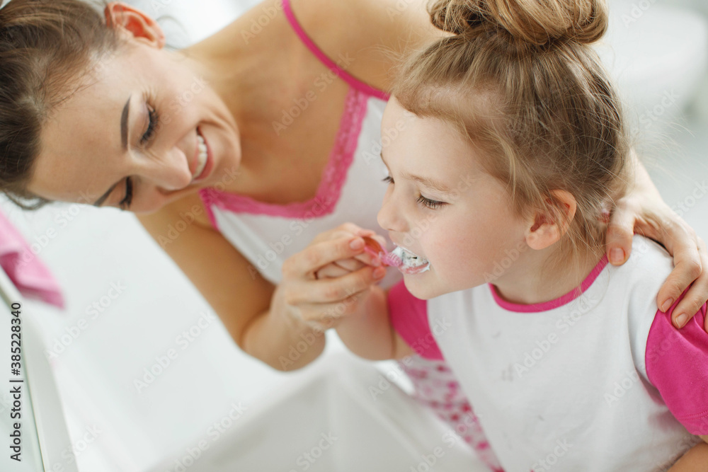 Mom and child brush their teeth. High quality photo. Mom and child brush their teeth. High quality photo.