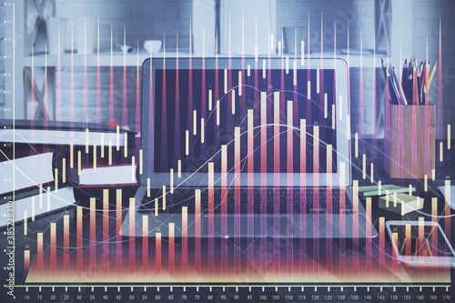 Financial graph colorful drawing and table with computer on background. Double exposure. Concept of international markets. © peshkova