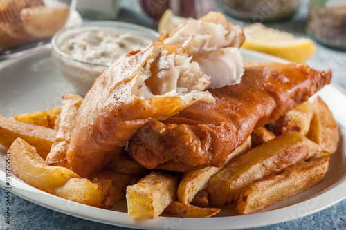 Fish in beer batter and chips with green pea and tartar sauce