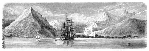 afar view of sailing ship alone in Fortesque bay waters among mountains, Chile. Ancient grey tone etching style art by De B�rard, Le Tour du Monde, Paris, 1861 photo