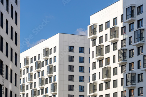 Multi-storey residential buildings with balconies. Laconic design in light colors. Modern apartments