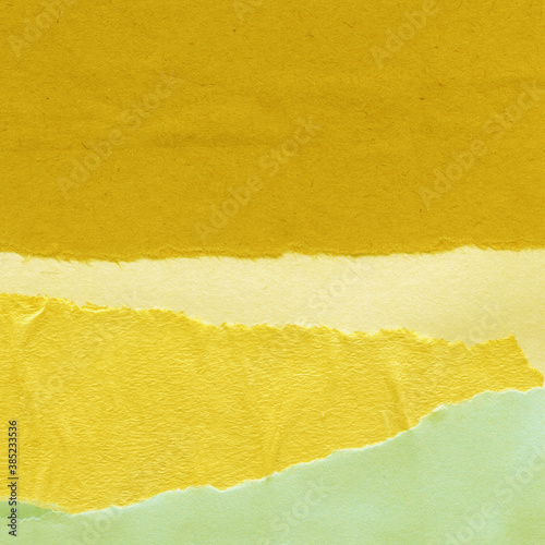 Colorful torn paper collage close-up. Texture made from various paper and cardboard parts. Damaged old paper background. Vintage blank wallpaper. Material design backdrop.