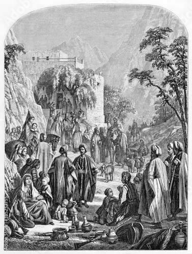 long tunic and turbans dressed Maronites people outdoor in Mar-Antoun convent. Ancient grey tone etching style art by Grandsire, Le Tour du Monde, Paris, 1861 photo