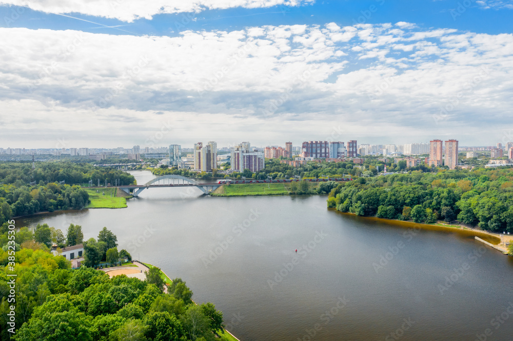 Aerial view of residential buildings in the city of Khimki and the railway bridge across the Moscow canal