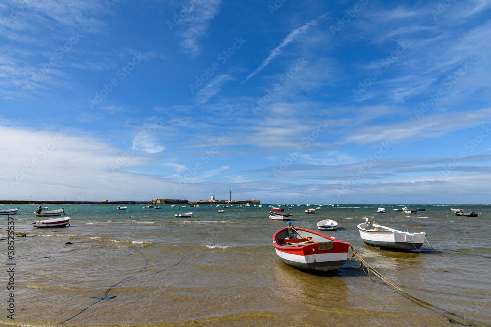 Fototapeta premium Small fishing boats by La Caleta beach in Cadiz, Andalusia, Spain