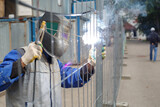 Working welder cooks metal structures. The process of welding metal products