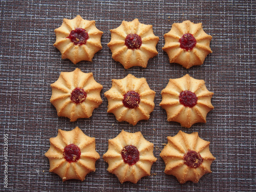 A few pieces of kurabye cookies lie on the brown tablecloth. photo