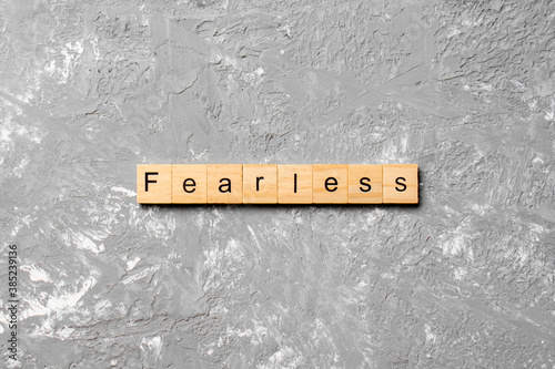 Fearless word written on wood block. Fearless text on cement table for your desing, concept