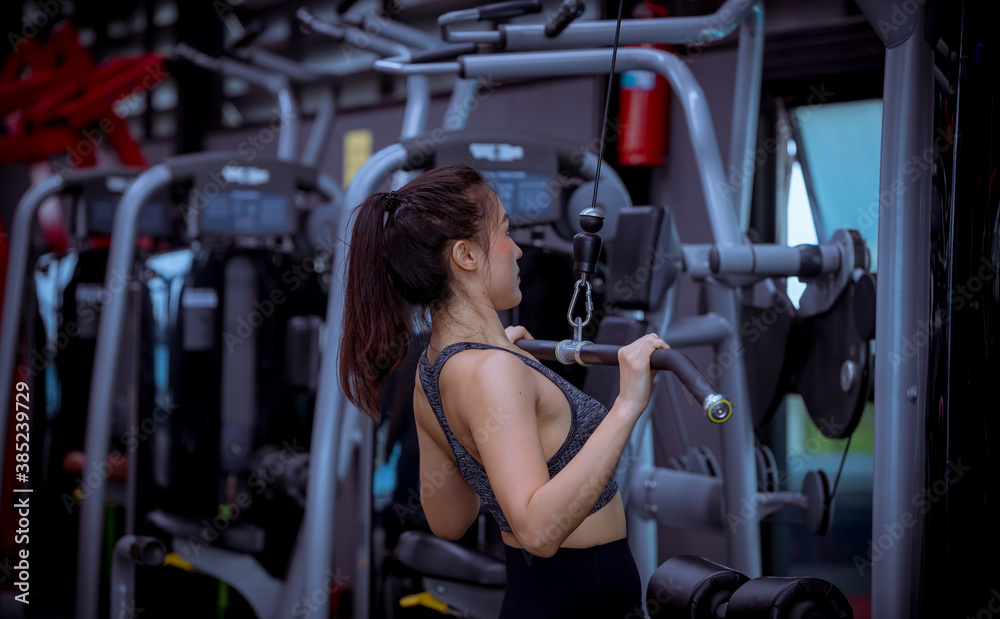 Portrait beauty sport woman wear sportwear posing under exercise with fitness equipment at gym ,she exercise for strong ,make muscle and good healthy. Portrait beauty sport woman wear sportwear posing under exercise with fitness equipment at gym ,she exercise for strong ,make muscle and good healthy.