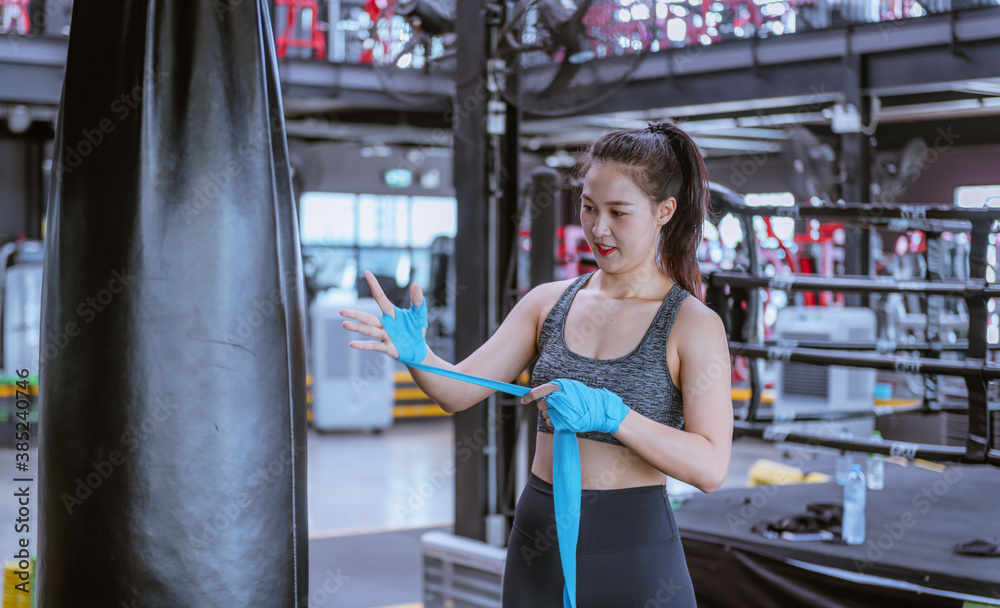 Portrait beauty sport woman wear sportwear posing under exercise with fighting fitness equipment at gym ,she exercise for strong ,make muscle ,protecting basic and good healthy..