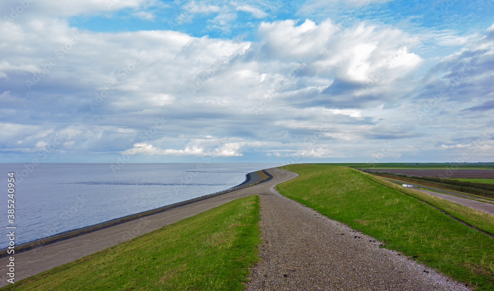 Landscape with dike along the Wadden sea in the Netherlands
