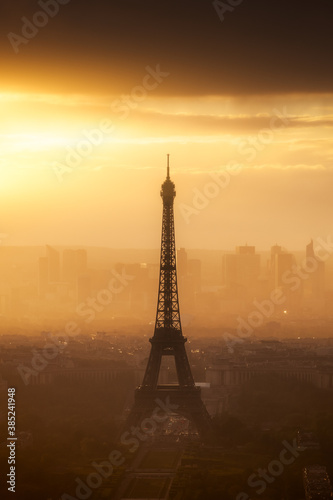 A misty sunset around the Eiffel Tower and the headquarter of La Défense