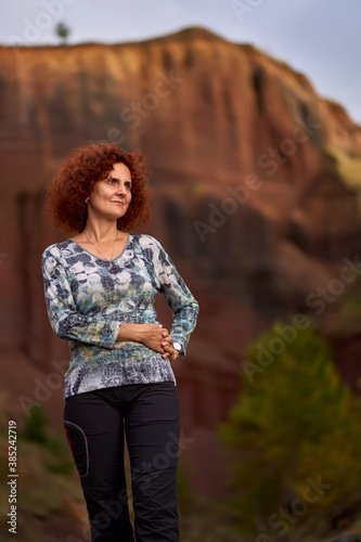 Redhead curly lady at sunset inside an extinct volcano