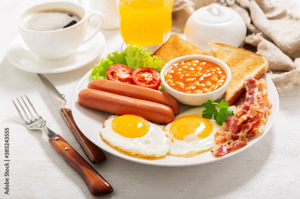 breakfast with plate of fried eggs, bacon, beans, sausages, toasts and tomatoes breakfast with plate of fried eggs, bacon, beans, sausages, toasts and tomatoes