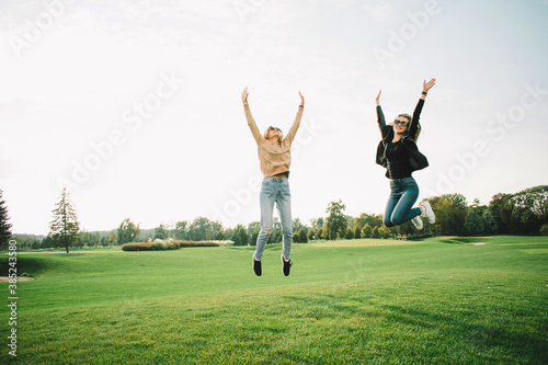 Happy young women on green meadow