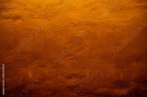 Copper colored wall texture background with textures of different shades of copper or bronze