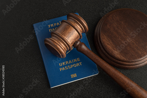 Judge gavel and ukrainian passport on black background. Passport Of Ukraine. Obtain citizenship