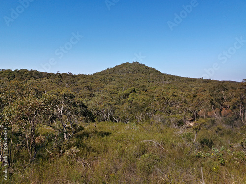 Beautiful afternoon view of mountain ranges, trees and deep blue sky from a trail, Willunga Trig Point Trail, Ku-ring-gai Chase National Park, Sydney, New South Wales, Australia 