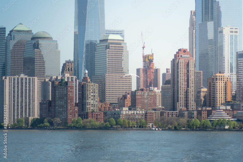 Naklejka premium Shot of the skyline of New York City from the Hudson river, with skyscrapers of the downtown district and Wall Street
