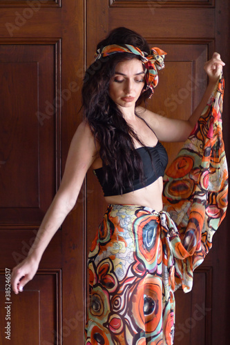 Female style. Feminine fashion model posing in boho style clothes on a street. Indoor fashion.