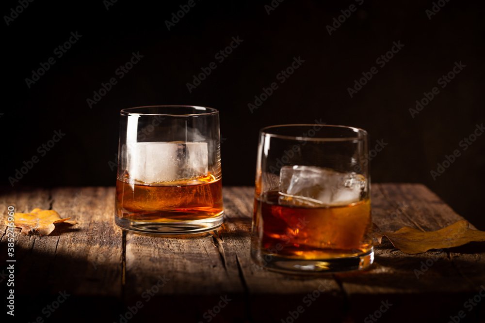 Glass of scotch whiskey and ice on wooden background Glass of scotch whiskey and ice on wooden background