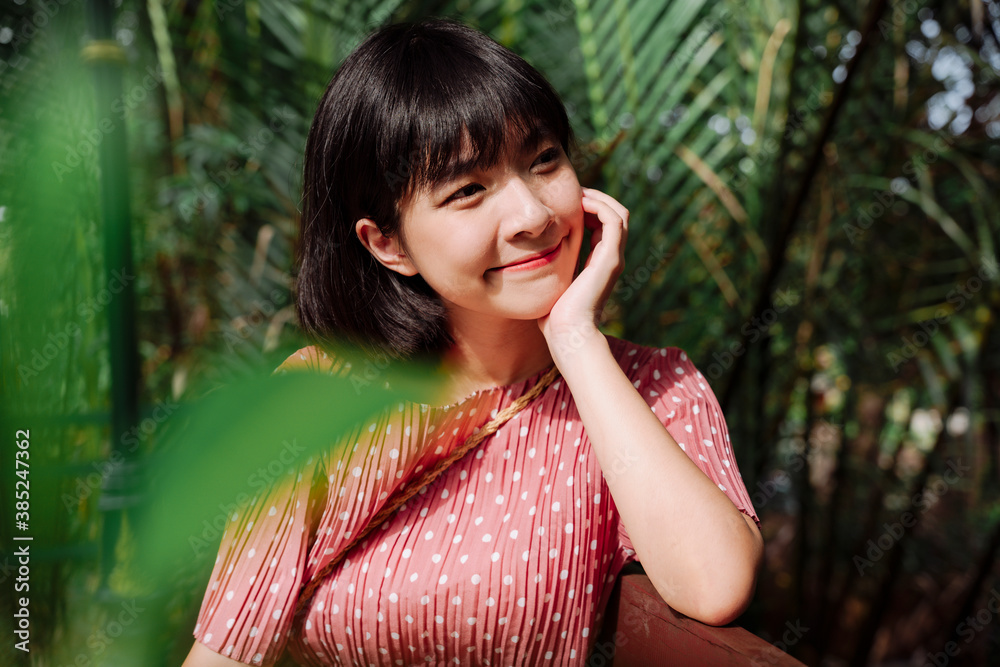 Beautiful asian woman short dark hair wearing pink dress at local cafe shop. Beautiful asian woman short dark hair wearing pink dress at local cafe shop.