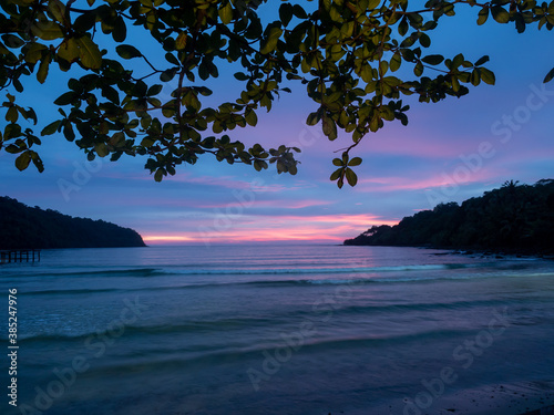 Beautiful bright sunset on a tropical paradise beach in Thailand. Travel concept. Copy space.