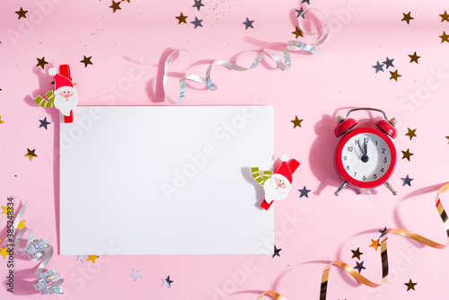 Christmas mockup card with shiny decoration and alarm clock.
