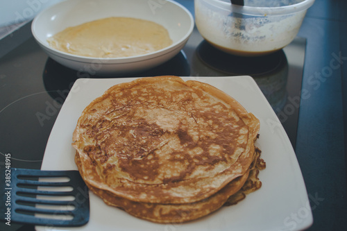 Dessert Nachspeise Vollkorn Crepes Pfannkuchen beim braten in einer weißen Pfanne mit Rührschüssel	