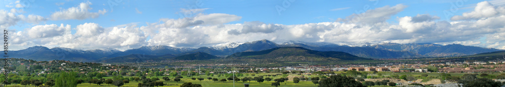 View on the Sierra de Guardarrama. A cold night has left snow behind on the peaks; clouds are hovering over the mountain range