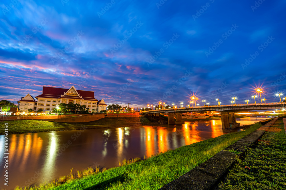 Fototapeta premium Natural evening at view the Nan River and the Naresuan Bridge in the park for relaxing walking jogging and exercise at sunset in Phitsanulok City, Thailand.