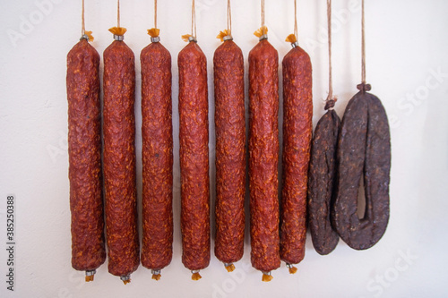 homemade sausage hanging on strings in storage