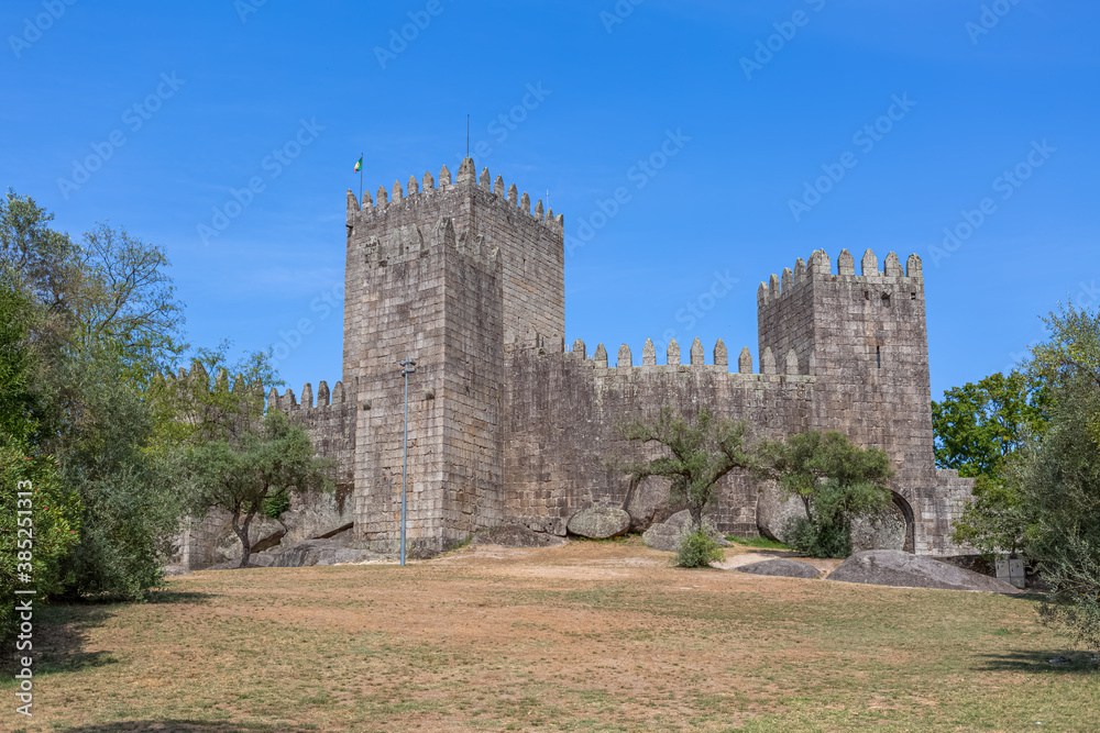 Front gate and facade view at the Castle of Guimarães, a iconic medieval castle, in the northern region of Portugal