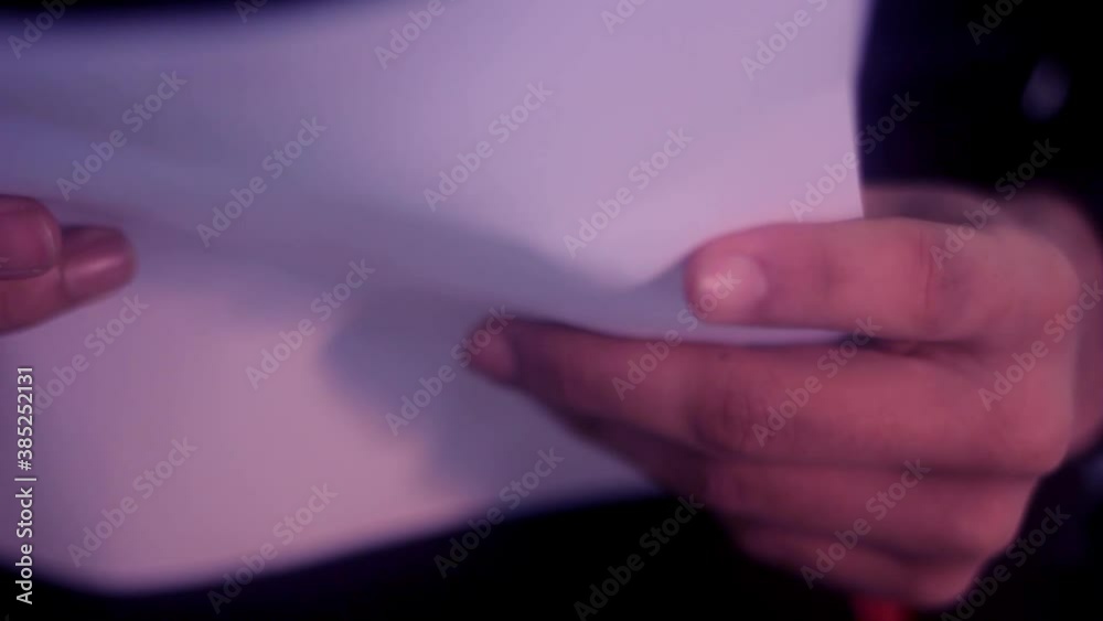 A man holding up and reading a paper A man holding up and reading a paper