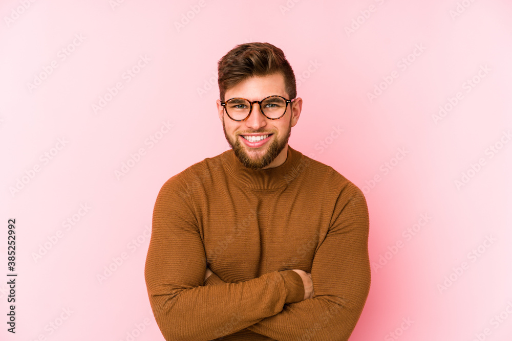Young caucasian man isolated on pink background laughing and having fun. Young caucasian man isolated on pink background laughing and having fun.