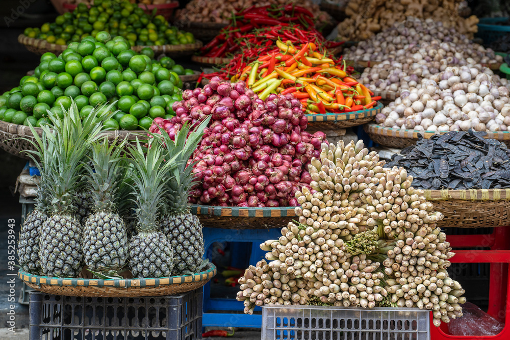 Fresh vegetables and fruits for sale at street food market in the old town of Hanoi, Vietnam